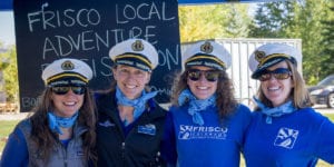 Four event staff with captains hats at Fall Locals Party