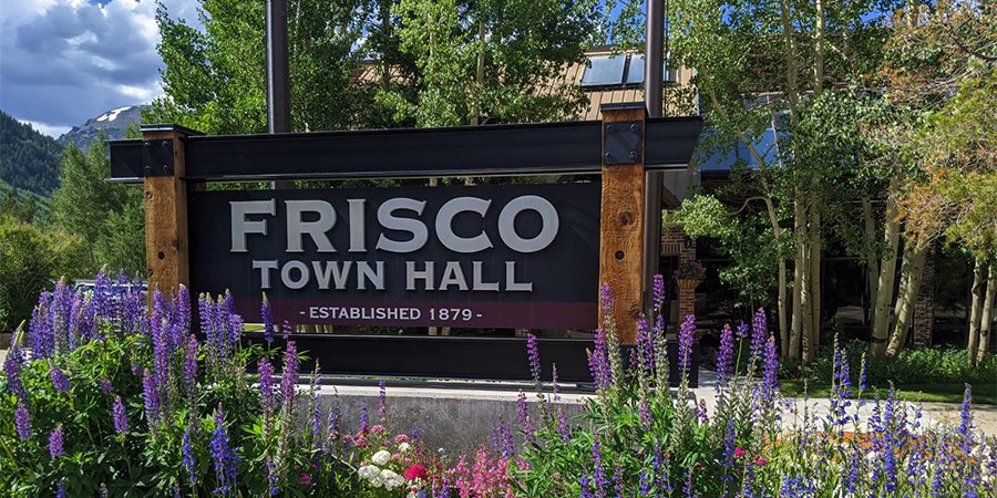 Frisco sign at Town Hall with purple flowers in front